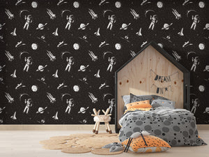 Papel tapiz negro con astronautas y naves espaciales